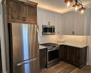 Stainless steel appliances with two toned cabinetry.